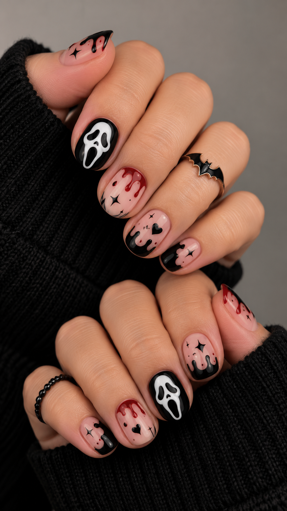 Nails with black and red dripping designs and ghost faces.